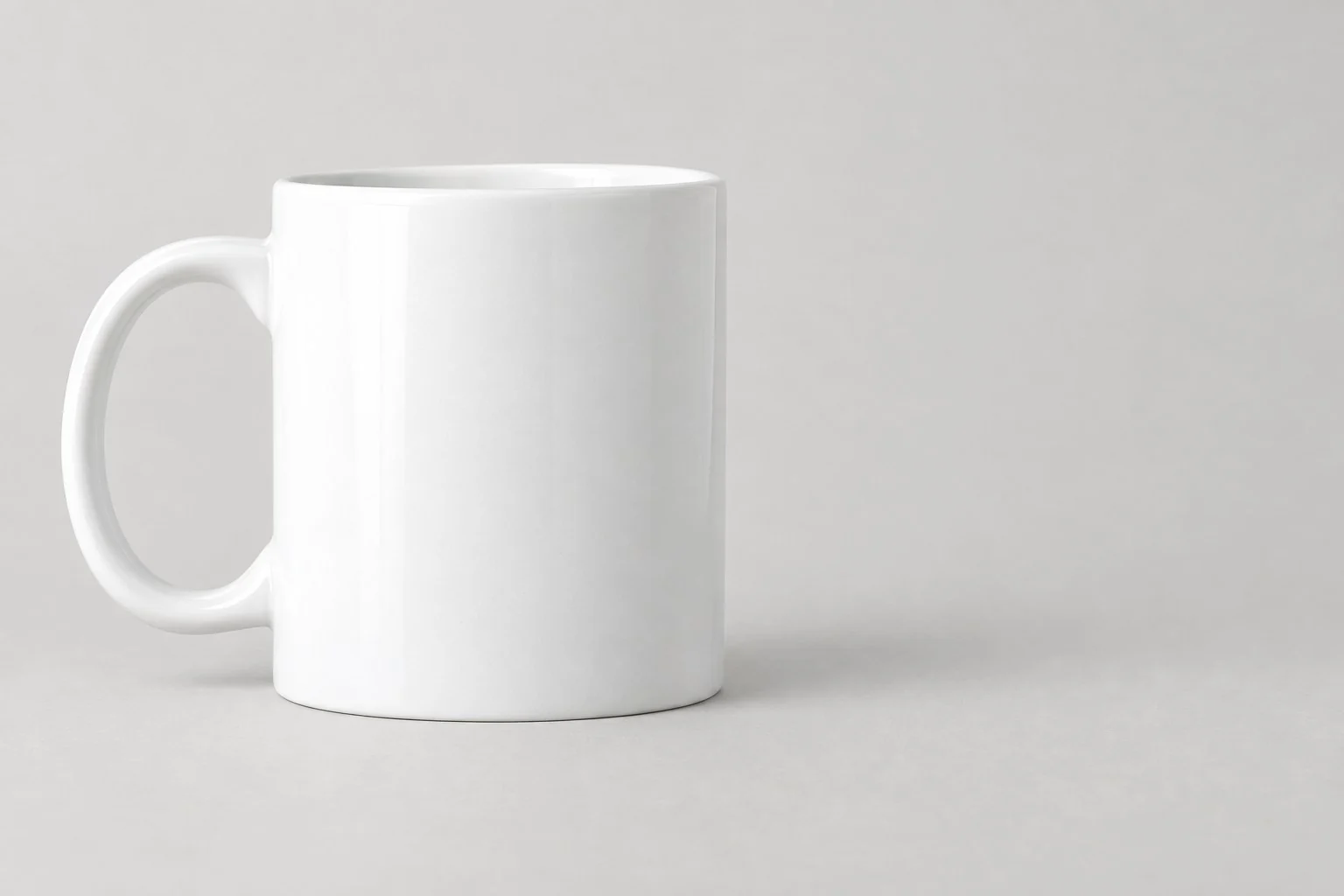 Plain white ceramic mug with a handle, without annotations