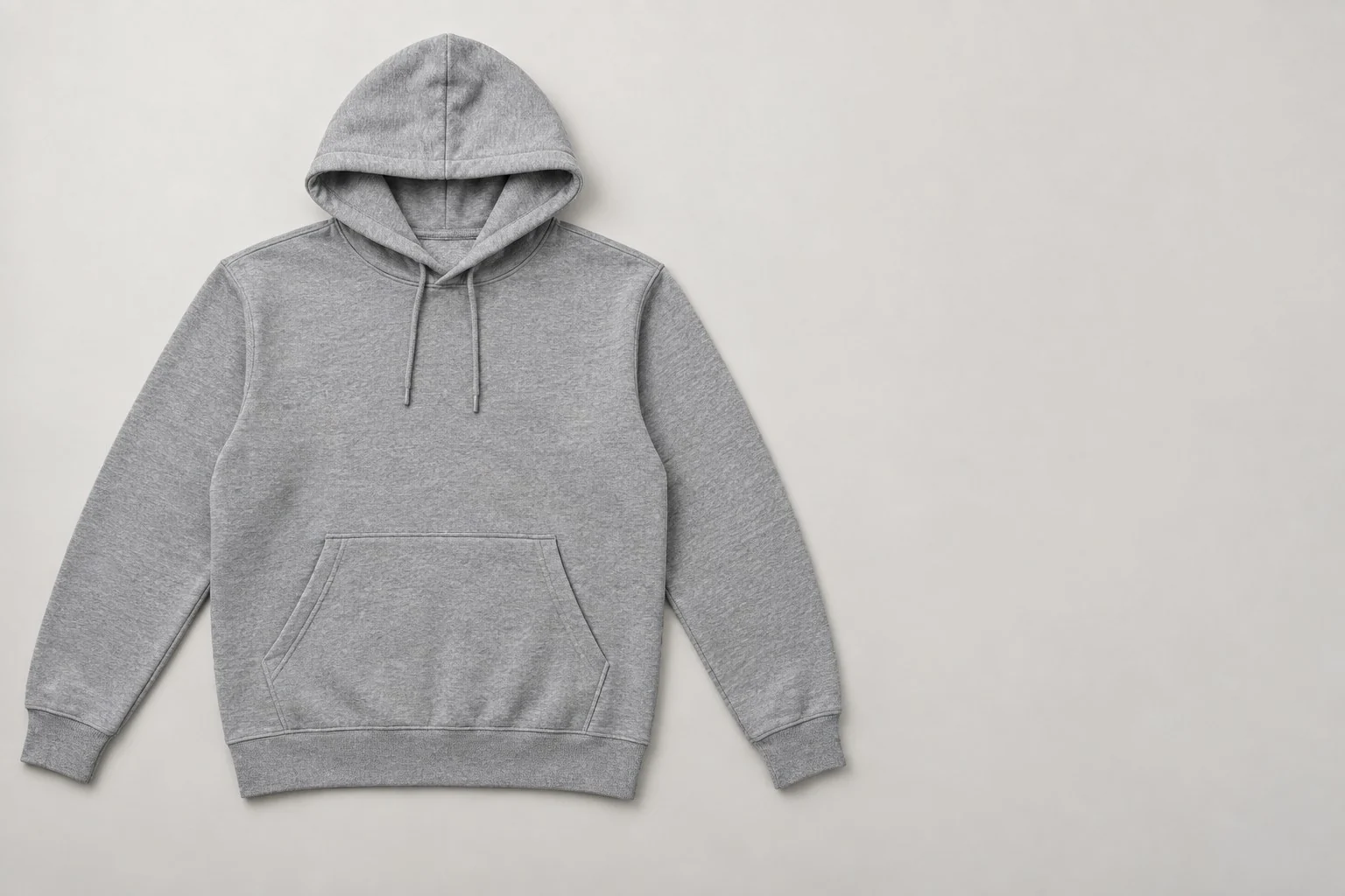 Grey pullover hoodie with a kangaroo pocket laid flat, without annotations